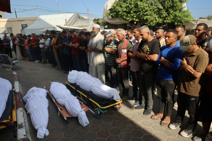 Palestinians mourn over the bodies of victims of Israeli bombardment in Deir el-Balah in central Gaza