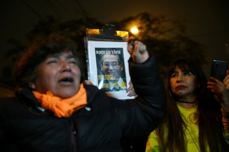 Supporters of former Peruvian president Alberto Fujimori shout slogans after his death outside the house of his daughter, Keiko Fujimori, in Lima