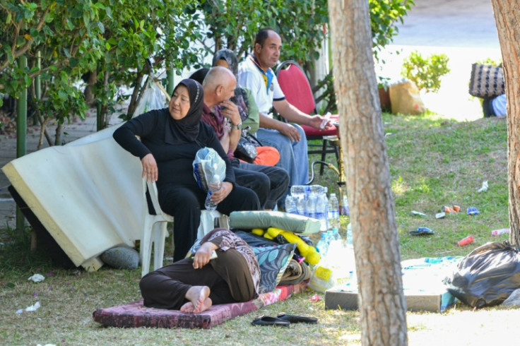 Displaced families who fled Israeli strikes in southern Lebanon at a park where they are taking refuge in Tripoli