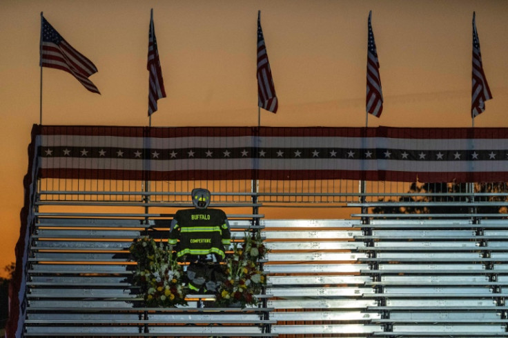 As campaign workers set up for the rally early on October 5, 2024, a shrine to Corey Comperatore -- the firefighter who died when a gunman began shooting at Trump during the July event -- can be seen