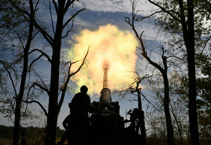 A Ukrainian artillery crew fires towards Russian positions on the front line in the Donetsk region