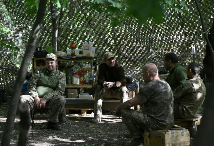 Ukrainian servicemen from the 43rd Artillery Brigade take a break at a position on the front line in Donetsk
