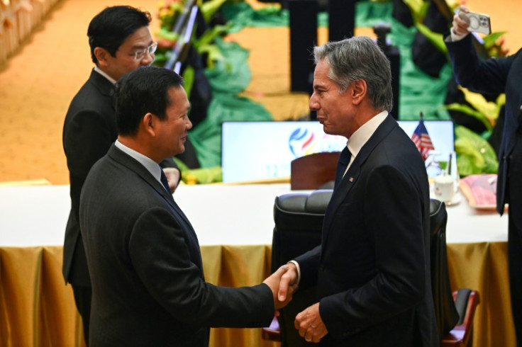 US Secretary of State Antony Blinken shakes hands with Cambodia's Prime Minister Hun Manet at an ASEAN meeting in Vientiane, Laos