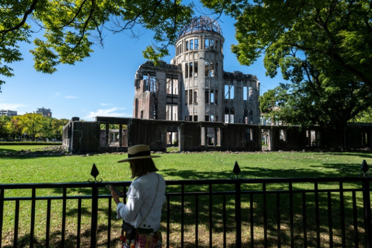 A woman visits the preserved skeleton of a building close to ground zero of where the atomic bomb was dropped in Hiroshima city