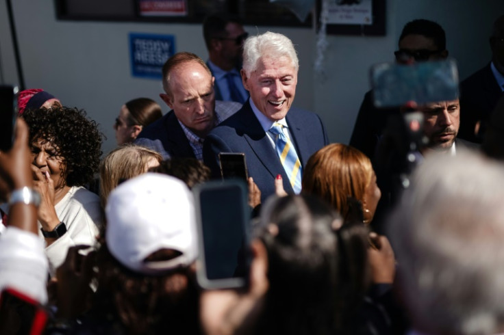 Former US president Bill Clinton shakes hands and poses for photos with supporters after speaking on behalf of the Harris/Walz campaign in swing state Georgia