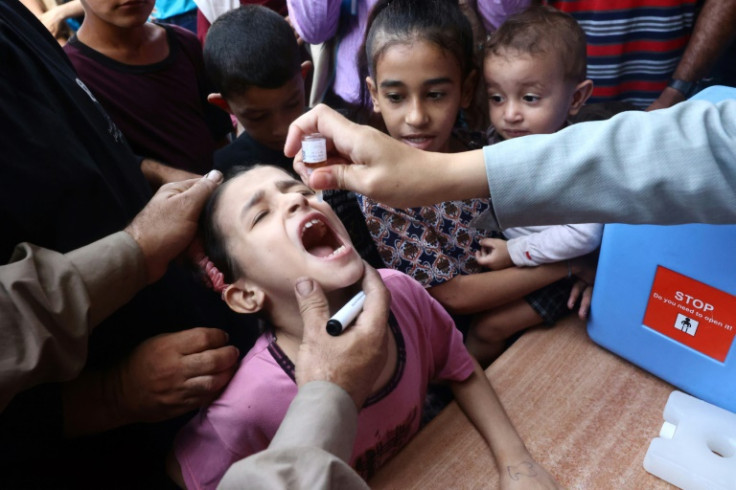 Palestinian children receive drops as part of a polio vaccination campaign in Deir el-Balah, central Gaza Strip