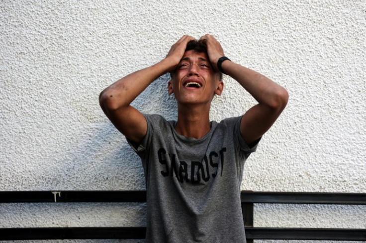 A Palestinian youth reacts to seeing the bodies of his relatives after an Israeli strike in Jabalia