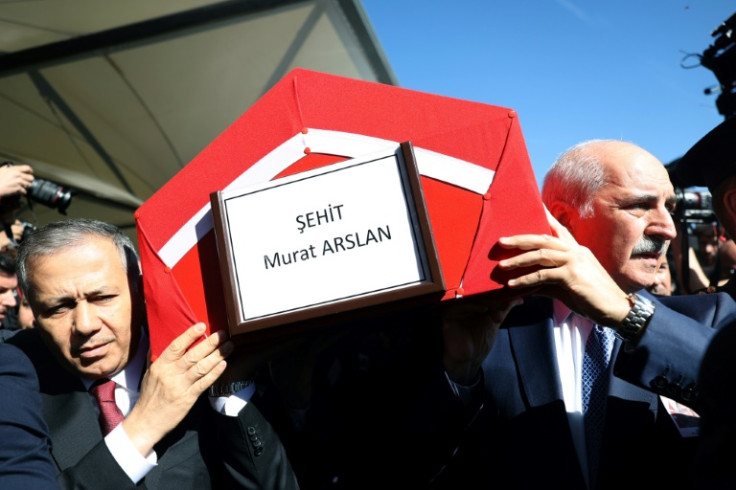 The coffin of Murat Arslan, the taxi driver killed in Wednesday's attack, was carried by Interior Minister Ali Yerlikaya, seen on the left, and parliamentary speaker Numan Kurtulmus, on the right