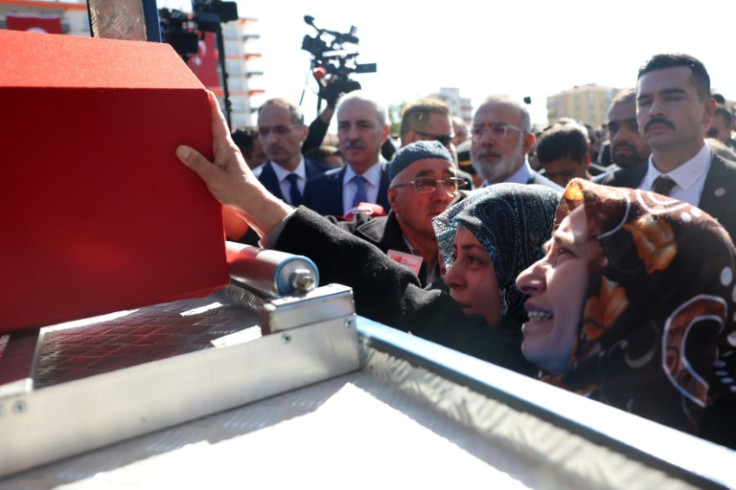 Family members mourn the death of taxi driver Murat Arslan who was killed during Wednesday's attack on the TAI defence firm