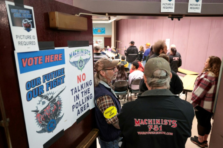 People look on as the Boeing Machinist union tallies votes on the latest Boeing contract offer at the District Lodge 751 Union Hall in Seattle, Washington on November 4, 2024
