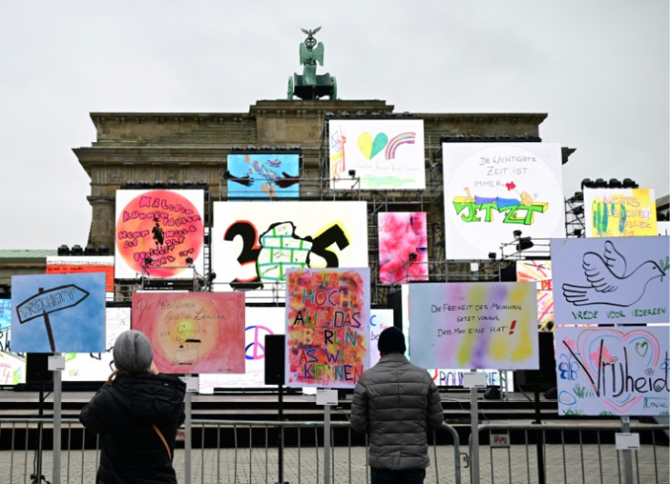Artworks on the theme of freedom stand in front of the Brandenburg Gate in Berlin