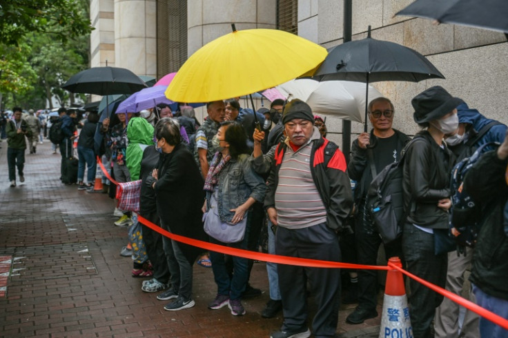 People queue outside the West Kowloon Magistrates' Court in Hong Kong to attend the largest national security trial ever held in the city