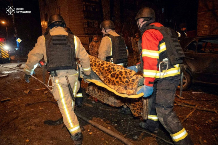 Ukrainian Emergency Service handout showing rescuers carrying a victim of an air attack on Sumy