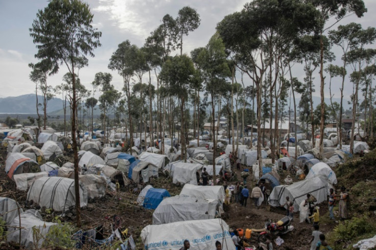 Newly displaced Congolese prepare to spend the night in the small houses they build next to the Bulengo camp a few kilometres from the centre of Goma, in the east of the Democratic Republic of Congo, on February 16, 2024