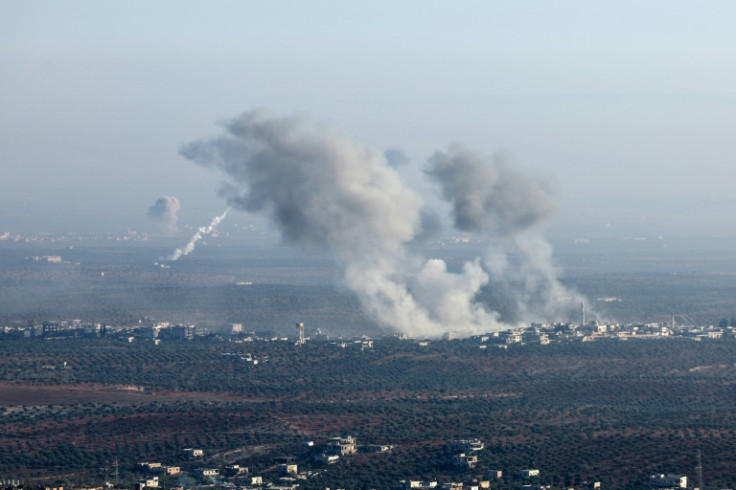 In this picture taken from the northern Syrian village of Ariha, smoke billows from the site of clashes between Syrian jihadists and allied factions and regime forces on the front lines on the outskirts of the city of Saraqib in Syria's Aleppo province o