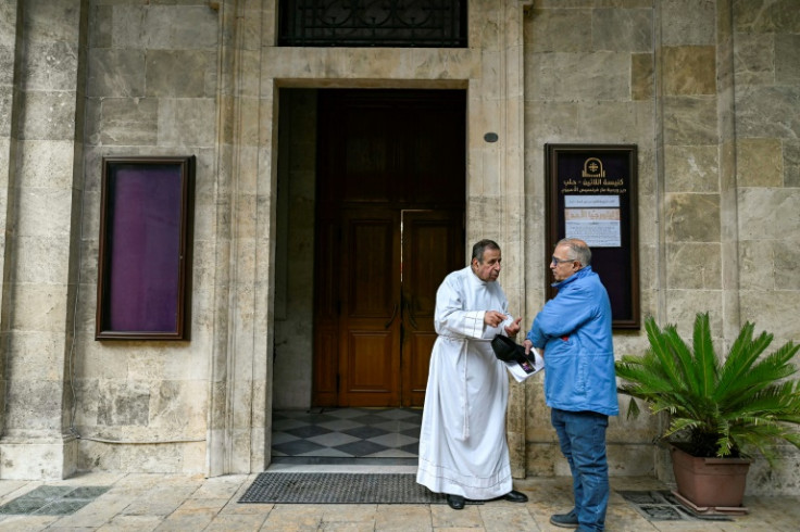 A priest speaks with a lay official at the Latin cathedral in Aleppo.