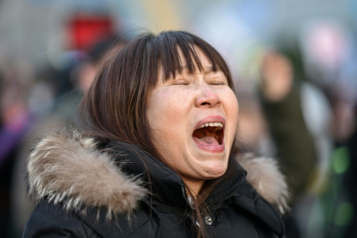 A protester calling for the ouster of South Korea President Yoon Suk Yeol reacts after the result of the second martial law impeachment vote outside the National Assembly in Seoul on December 14, 2024. South Korean lawmakers on December 14 voted to remove