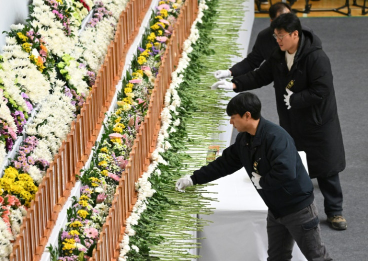 Mourners pay their respects at a memorial altar for victims of the Jeju Air plane crash, at Muan Sports Park in Muan on December 30, 2024