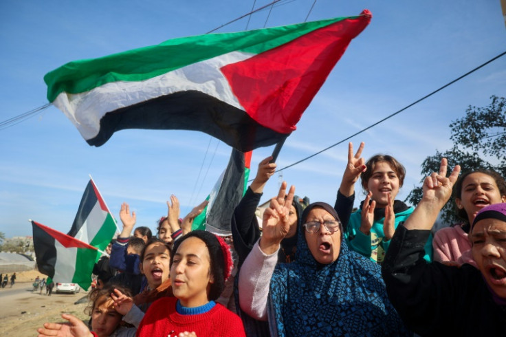 Gazans celebrate as they return to Rafah after the ceasefire went into effect on Sunday