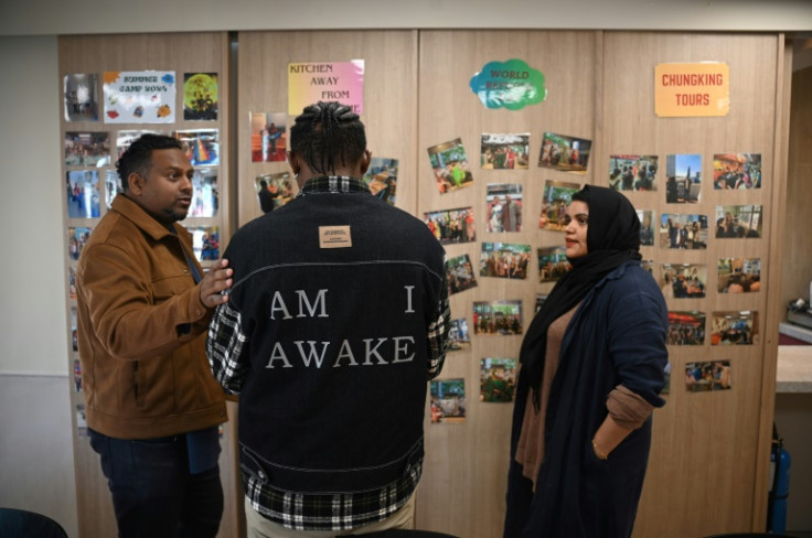 'John' (C), who fled persecution in an East African nation, had been set for resettlement in the United States until President Donald Trump halted refugee arrivals