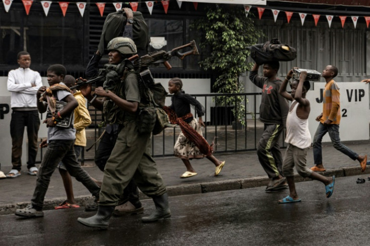 A member of the M23 armed group walks through a street of the Keshero neighborhood in Goma, on January 27, 2025