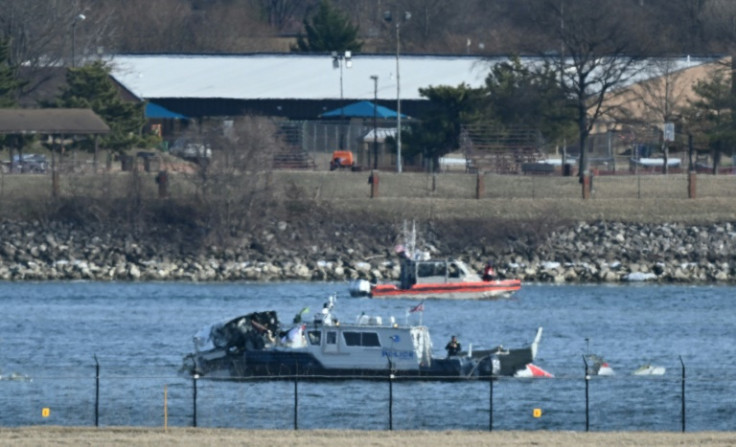 A police boat gathers wreckage along the Potomac River after American Airlines flight 5342 collided with a US Army helicopter