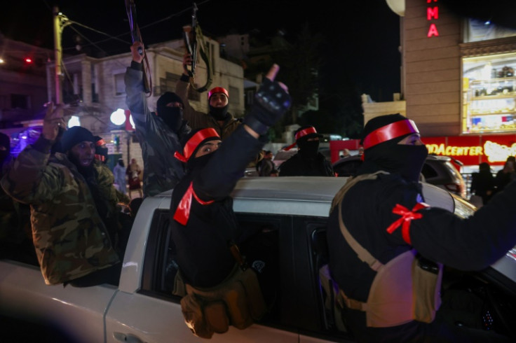 Members of Syria's new security forces depart from the northwestern city of Idlib to reinforce the coastal regions