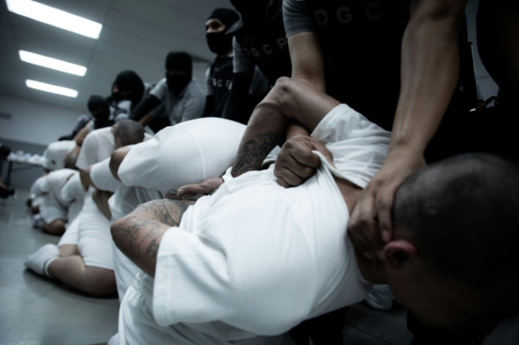 This picture released by El Salvador's Presidency press office shows alleged members of the Venezuelan criminal organization Tren de Aragua upon arrival at sprawling CECOT prison in El Salvador, after US President Donald Trump ordered their expulsion