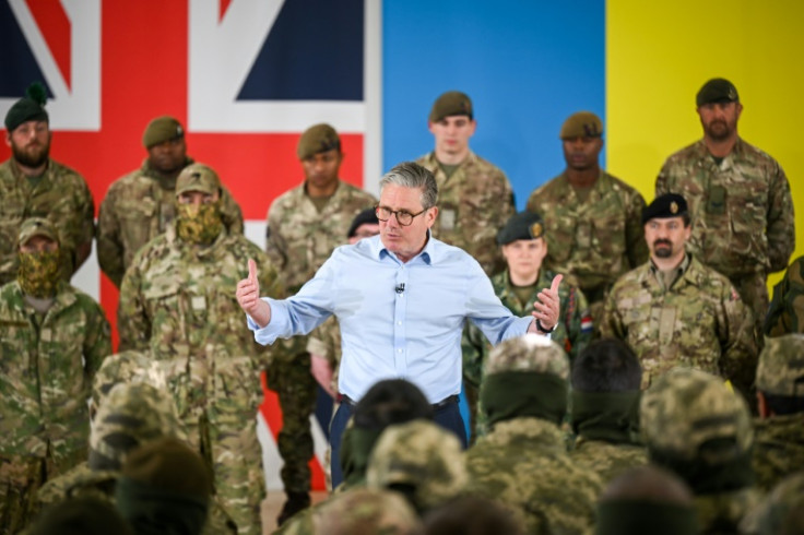 Britain's Prime Minister Keir Starmer (C) speaks on stage to the troops during a visit to a British army base in the west of England, on April 22, 2025, where they saw the training of Ukrainian forces by the UK and New Zealand military