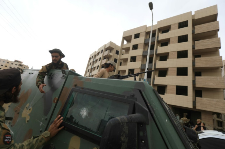 Members of Syria's security forces deploy in an area near the Syrian capital Damascus