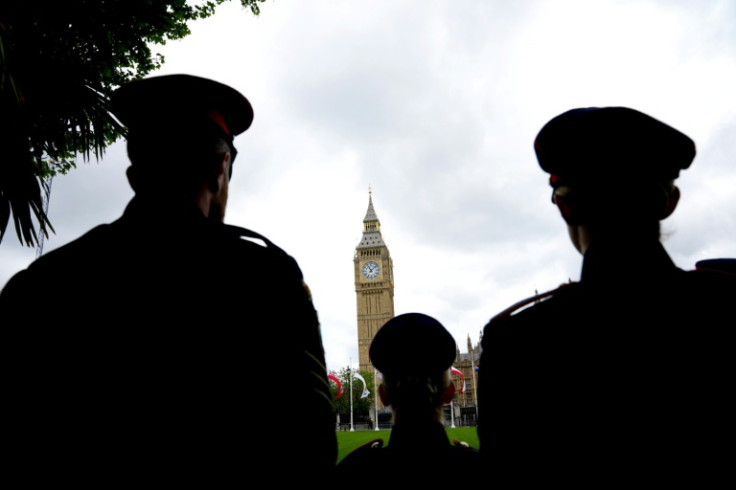 Military personnel stand opposite Big Ben ahead of VE Day celebrations