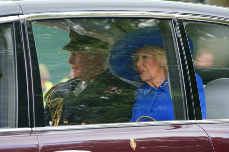 King Charles III (L) and Queen Camilla arrive ahead of a procession celebrating the 80th anniversary of VE Day in central London