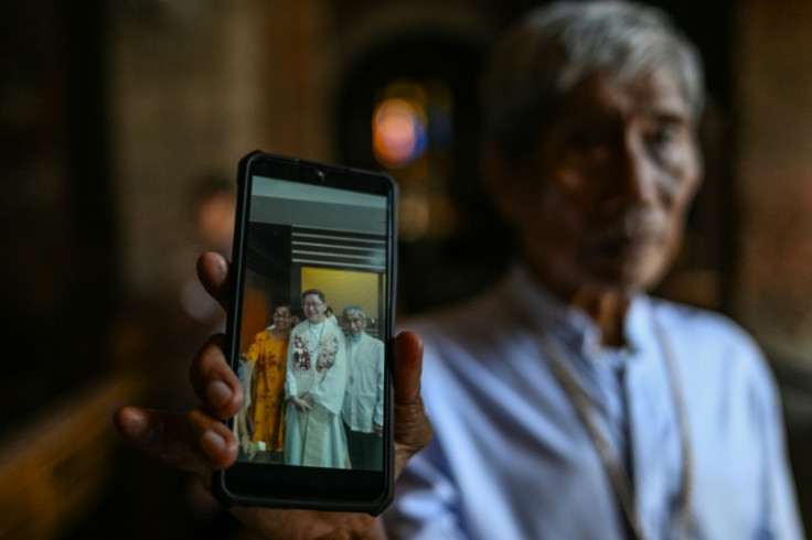 Francisco Abella Jr., a lay minister, shows a photo of him and Philippine Cardinal Luis Antonio Tagle at the Imus Cathedral