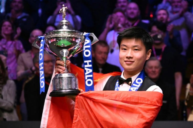 China's Zhao Xintong poses with the World Snooker Championship trophy