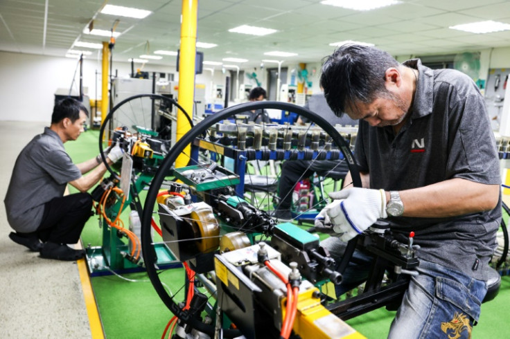 Workers check bicycle wheels at a Joy Group factory in Taichung on April 24, 2025