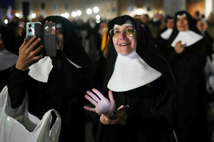 Tens of thousands of pilgrims and well-wishers thronged St Peter's Square on the first day of conclave