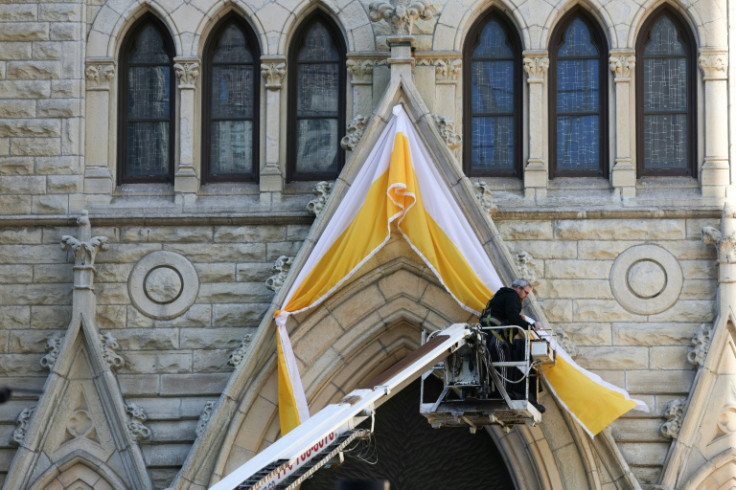 A worker in Chicago hung papal bunting over the entrance to the Holy Name Cathedral, after Chicago native Cardinal Robert Prevost was named the first American leader of the Catholic Church