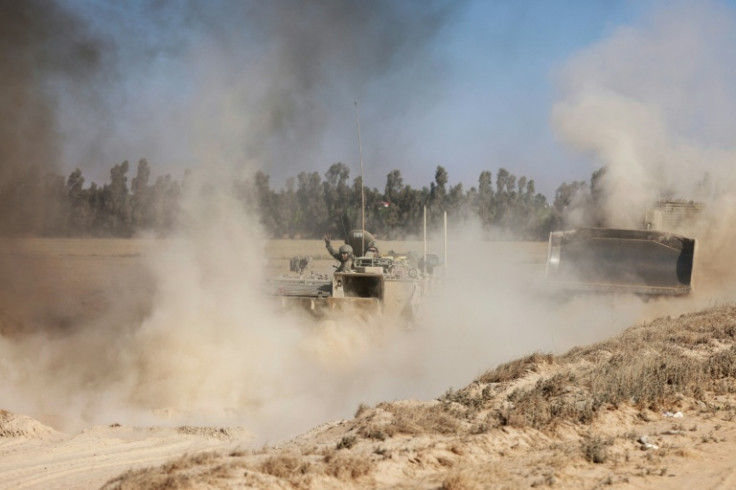 A picture taken near Israel's border with Gaza shows Israeli armoured vehicles and bulldozers returning from the besieged Palestinian territory on May 8, 2025, amid the ongoing war between Israel and the Palestinian militant movement Hamas.