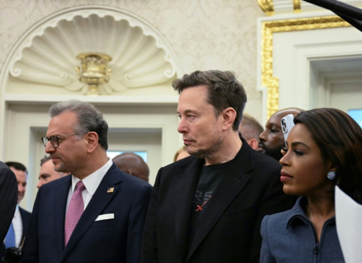 Co-leader of the Department of Government Efficiency Elon Musk (C) looks on as US President Donald Trump meets with South African President Cyril Ramaphosa in the Oval Office of the White House in Washington, DC, on May 21, 2025. South African President C