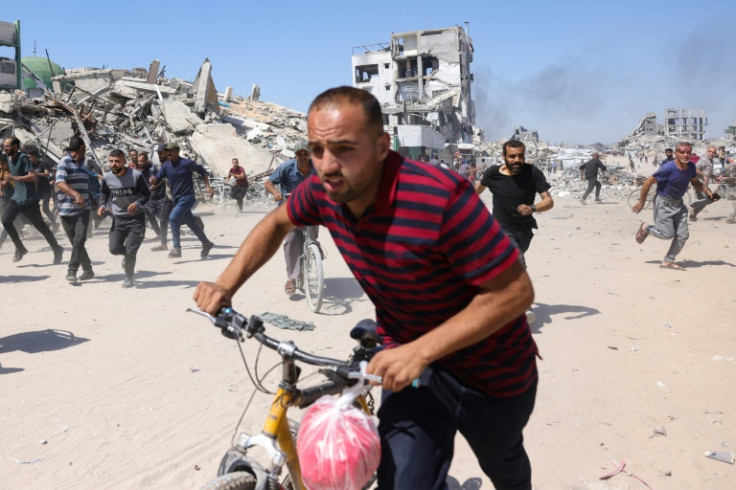 Palestinians run for cover during an Israeli drone strike in Jabalia, in the northern Gaza Strip
