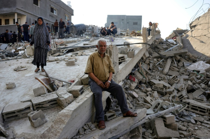 People check the destruction following an Israeli strike that hit the home of a Palestinian family in Jabalia in the northern Gaza Strip