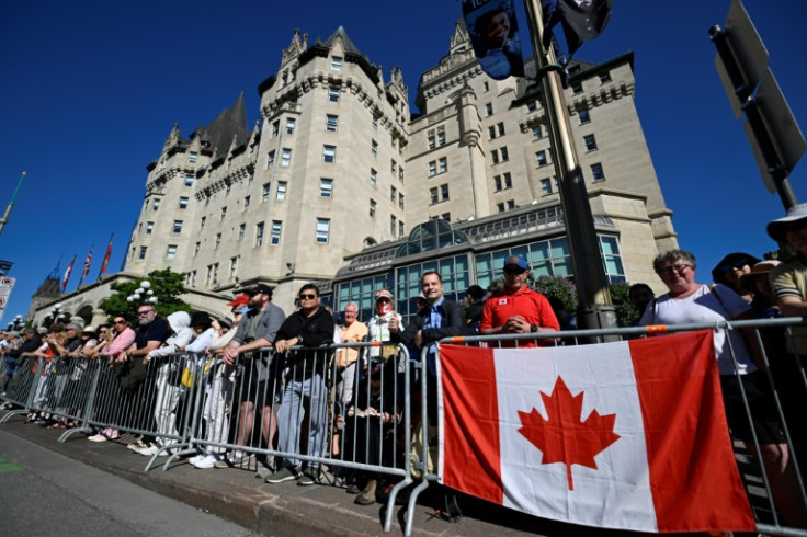 Thousands gathered along a parade route early Tuesday morning for a chance to see their monarch