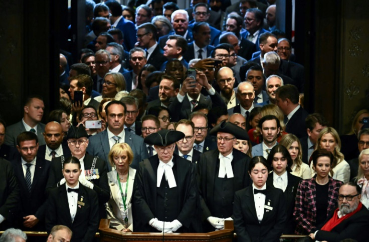 Members of Parliment watch from the Senate doors as King Charles III delivers a throne speech