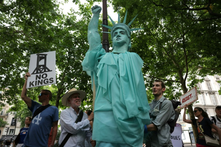 Demonstrators hold a Statue of Liberty during a 'No Kings' protest in Paris