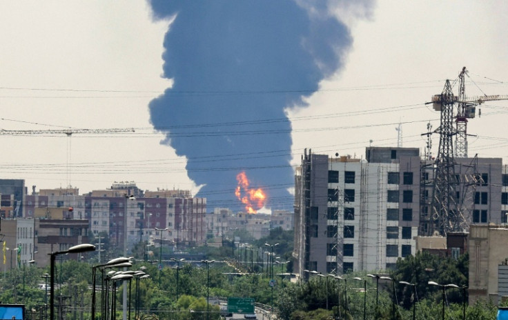 A plume of heavy smoke and fire rise over an oil refinery in southern Tehran, after an overnight Israeli strike