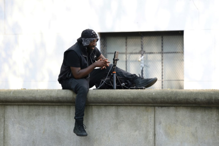 A man livestreams outside the Manhattan federal courthouse, where Sean "Diddy" Combs is on trial for sex trafficking and racketeering charges