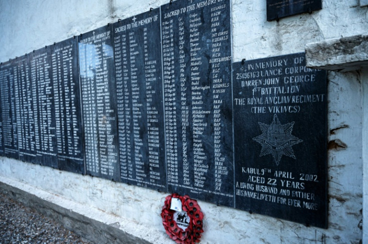 Plagues bearing names of soldiers who died during the Afghan War are displayed on a memorial wall at the British Cemetery in Kabul
