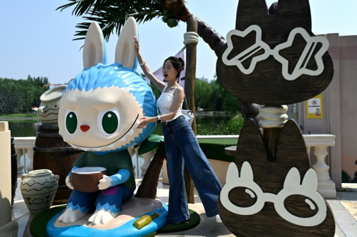 A visitor poses for a picture at the Pop Land them park