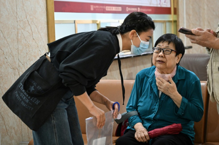 Patient companion Meng Jia with patient Gao Yingmin at a traditional Chinese medicine hospital in Beijing