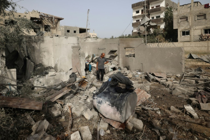 A Palestinian man examines the damage to a house in Deir el-Balah on Tuesday following overnight Israeli strikes